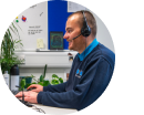 Canine Behaviour team member at a desk speaking speaking with a supporter on the phone
