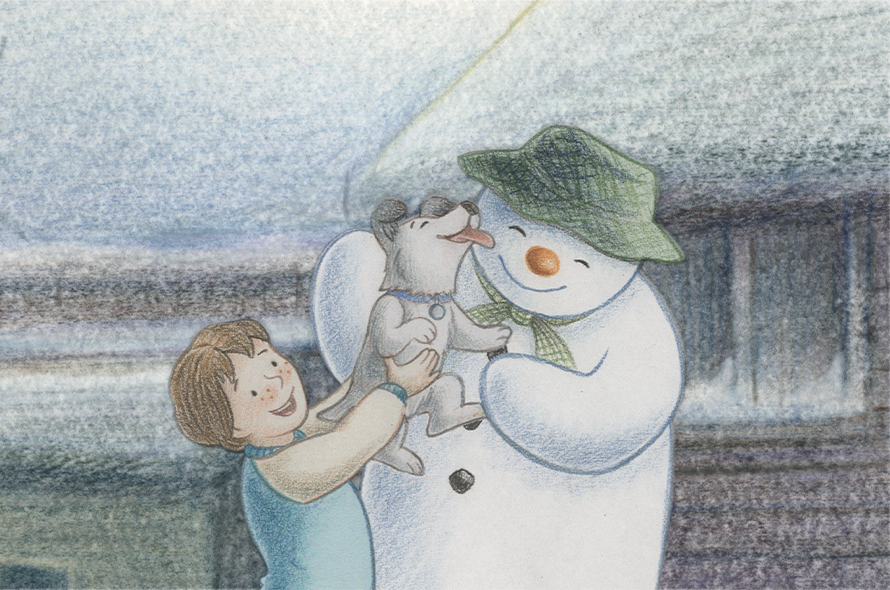 A little boy, snowdog and snowman playing togther