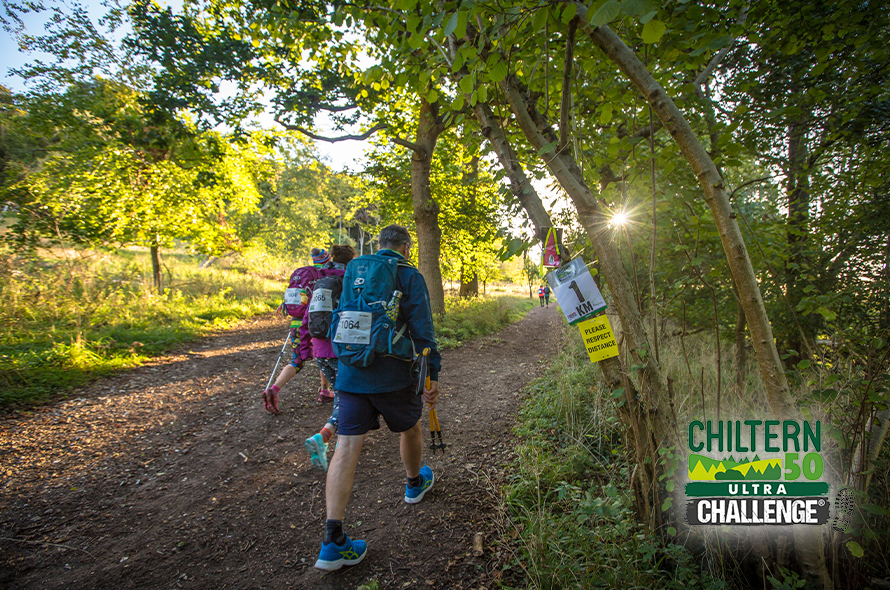 Three people trekking along a path, with the words Chiltern Hills Challenge overlaying the image