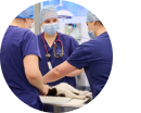 Three vets performing surgery on a cat