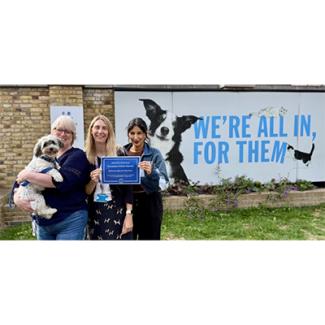 3 women standing in front of Battersea sign,
