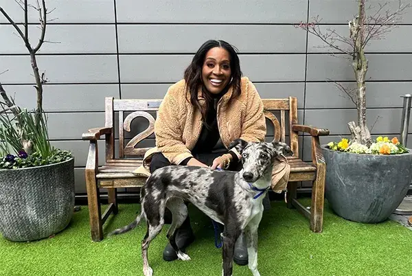 Alison Hammond sat on a bench with a Lurcher