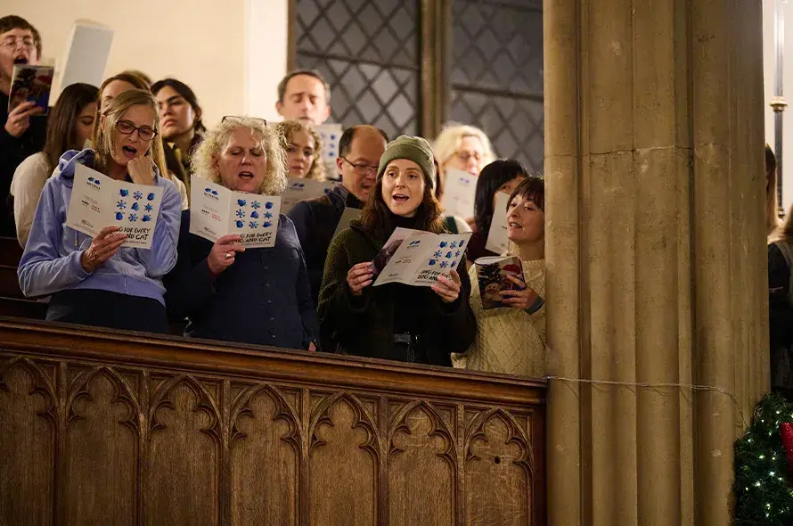 Group of people singing Christmas carols