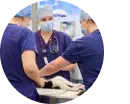 Three vets performing surgery on a cat